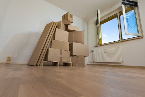 Moving boxes and furniture being loaded for a local removals job