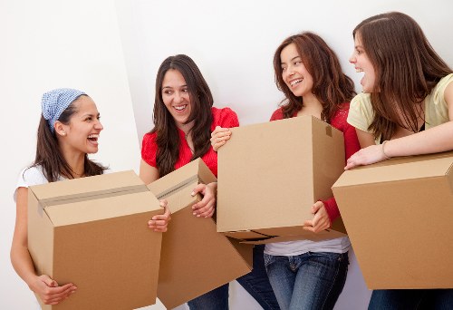 Professional movers handling desks and IT items carefully
