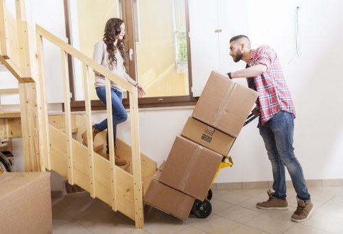 Professional movers carrying furniture in a Belsize Park flat move